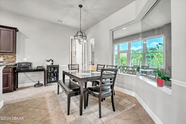 tiled dining area with a notable chandelier