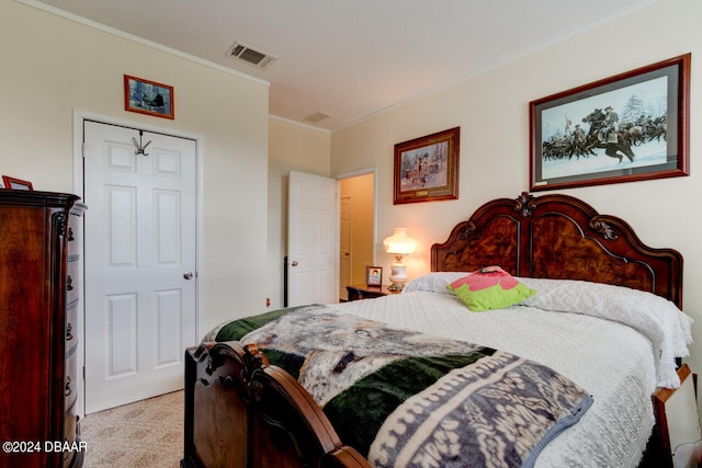 carpeted bedroom with ornamental molding