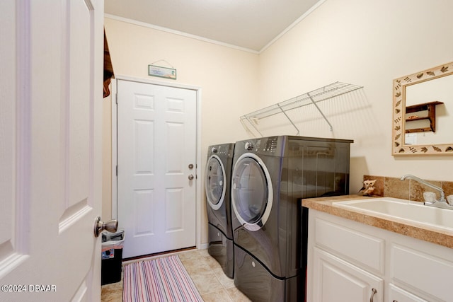 laundry area with crown molding, washer and clothes dryer, sink, and light tile patterned flooring