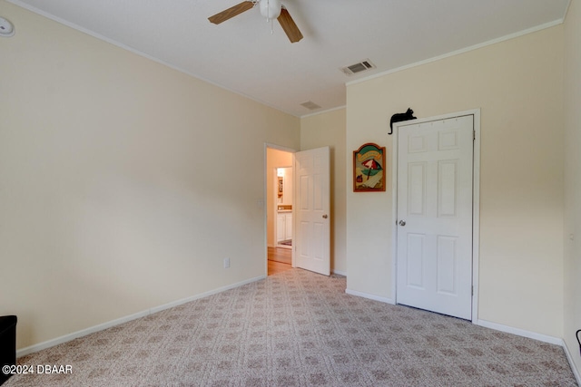 unfurnished bedroom with light carpet, ceiling fan, and crown molding