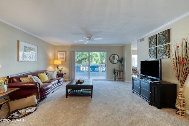 carpeted living room featuring ceiling fan and crown molding