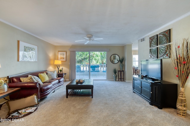 living room with ceiling fan, light carpet, and crown molding