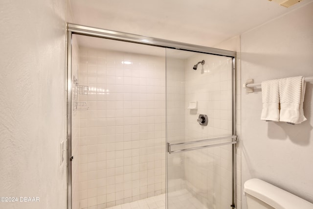 bathroom with walk in shower and toilet