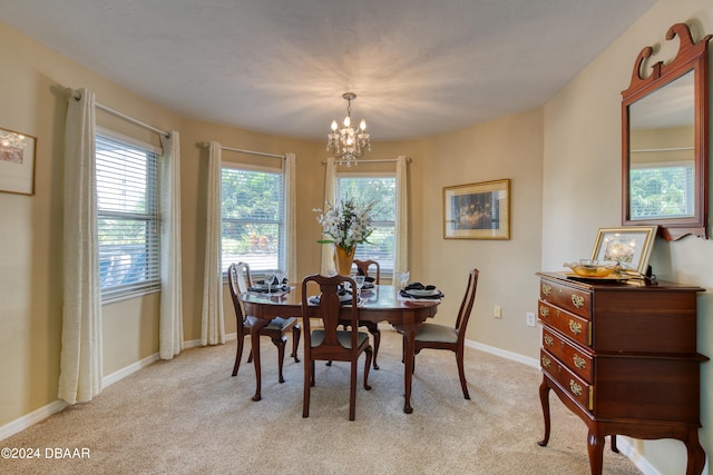 dining space featuring a chandelier and light carpet