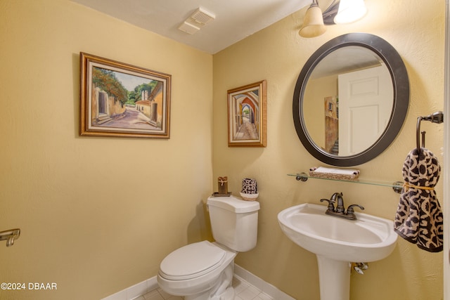 bathroom featuring tile patterned flooring, toilet, and sink