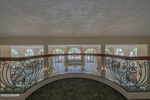 hall featuring a textured ceiling