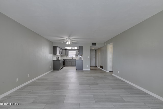 unfurnished living room featuring ceiling fan, baseboards, and visible vents