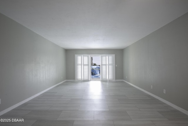 spare room featuring baseboards
