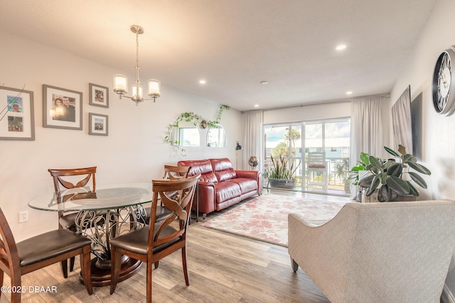 325 N Causeway Cswy Unit B305, New Smyrna Beach, FL 32169 - dining space featuring wood finished floors, recessed lighting, and a chandelier
