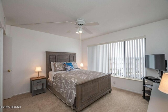 4849 Saxon Dr Unit C202, New Smyrna Beach, FL 32169 - bedroom featuring multiple windows, light carpet, and baseboards