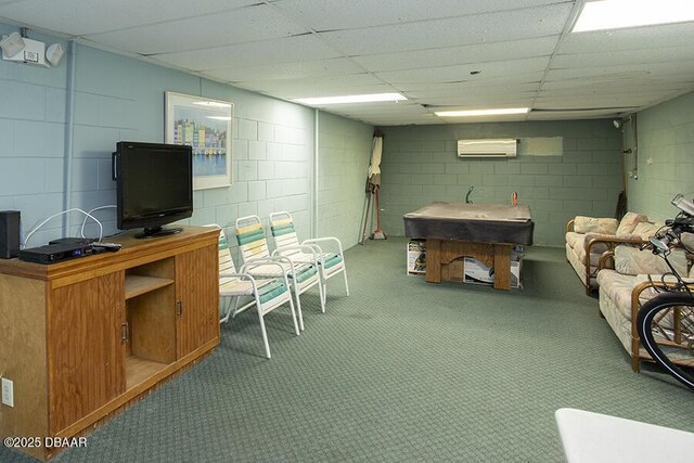 4849 Saxon Dr Unit C202, New Smyrna Beach, FL 32169 - finished basement with an AC wall unit, concrete block wall, carpet, and a paneled ceiling