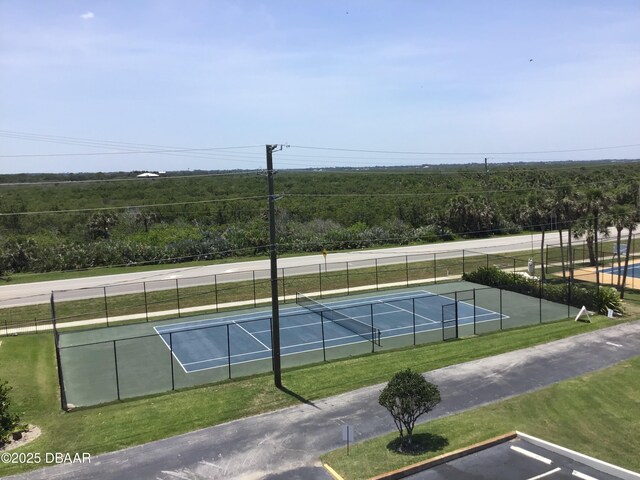 4849 Saxon Dr Unit C202, New Smyrna Beach, FL 32169 - view of tennis court featuring a forest view