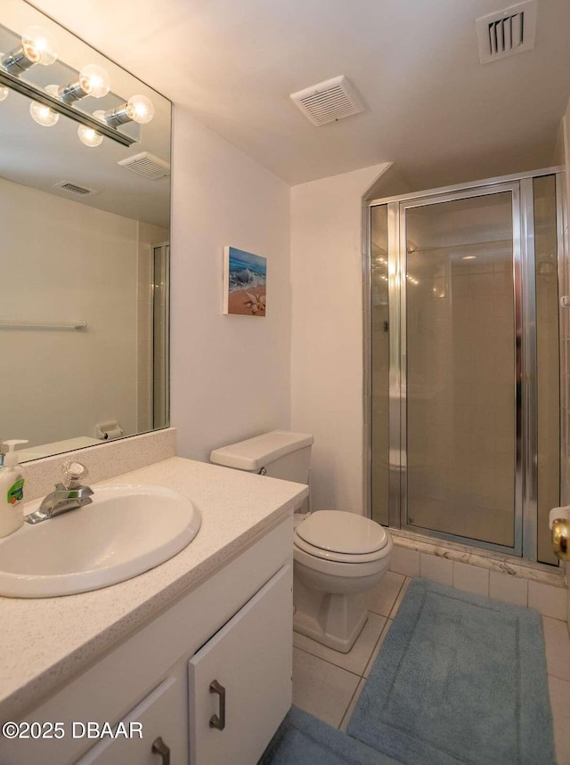 4849 Saxon Dr Unit C202, New Smyrna Beach, FL 32169 - full bath with tile patterned floors, vanity, toilet, and a shower stall