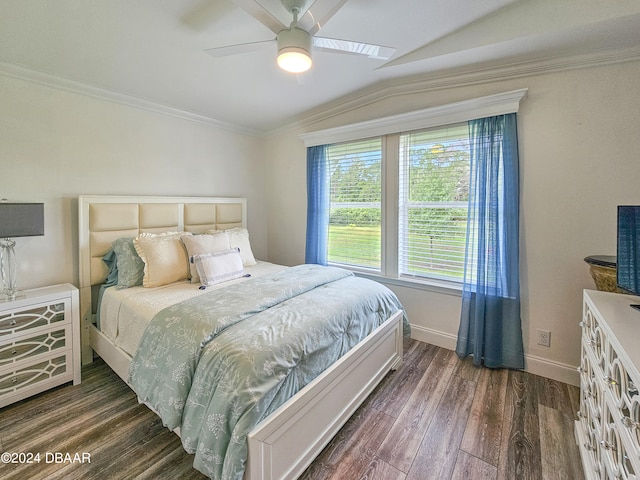 bedroom featuring ceiling fan, dark hardwood / wood-style floors, vaulted ceiling, and ornamental molding