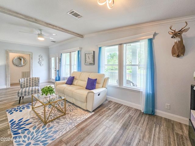 living room with ceiling fan, wood-type flooring, and ornamental molding