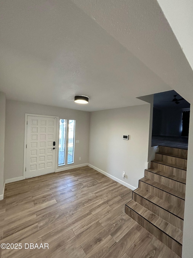 foyer entrance featuring a textured ceiling and light hardwood / wood-style flooring