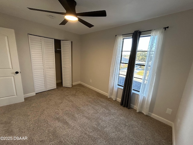 unfurnished bedroom featuring carpet floors, ceiling fan, and a closet