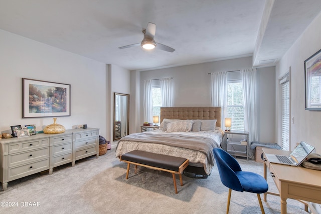 carpeted bedroom with ceiling fan and multiple windows