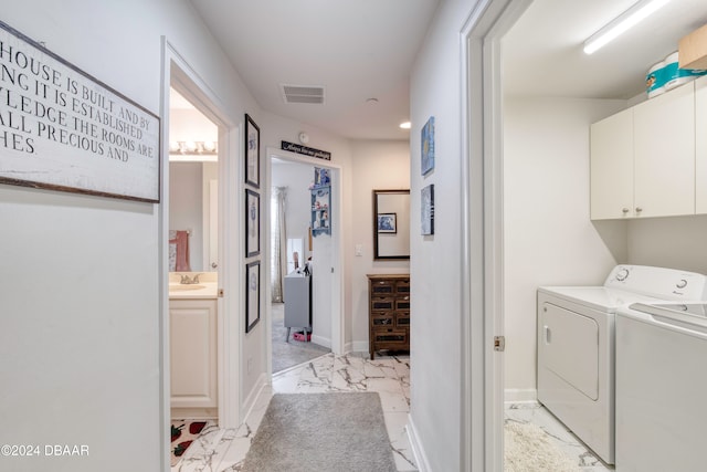 laundry area with cabinets, sink, and washing machine and clothes dryer