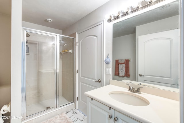 bathroom with vanity and a shower with door