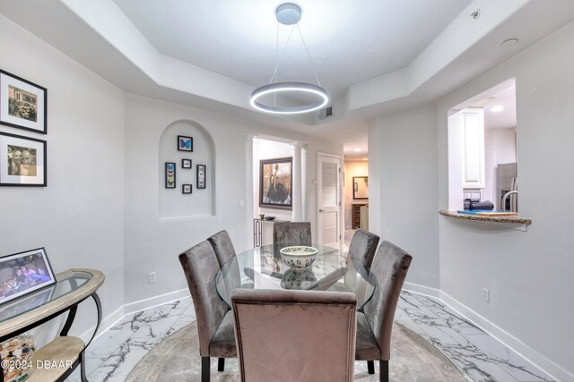 dining area featuring a tray ceiling