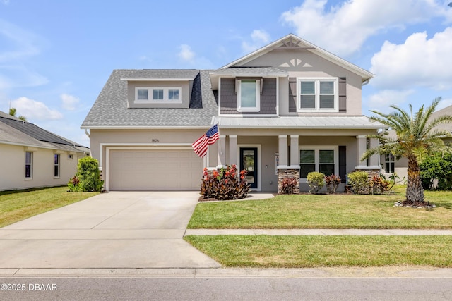 craftsman-style house with covered porch, driveway, a front yard, and stucco siding