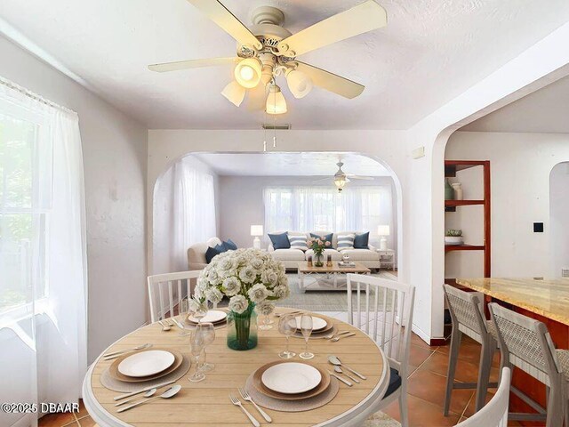 410 Riverview Blvd, Daytona Beach, FL 32118 - dining area featuring arched walkways, ceiling fan, and tile patterned flooring