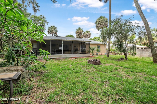 2509 Kumquat Dr, Edgewater, FL 32141 - rear view of property featuring an outdoor fire pit and a sunroom