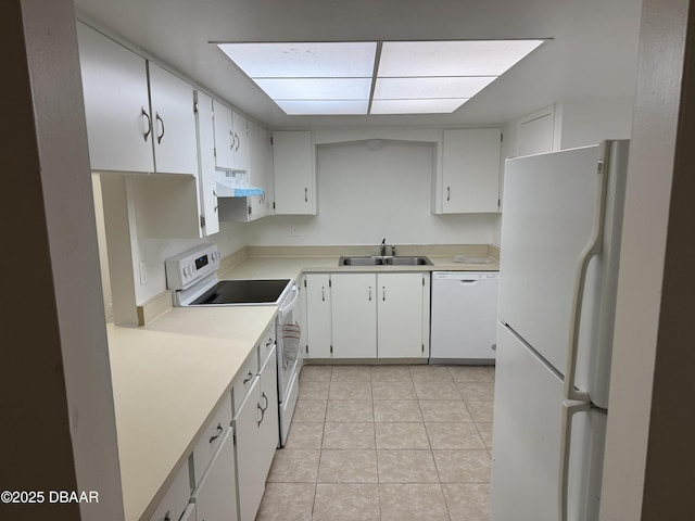 kitchen with a sink, light tile patterned flooring, white appliances, light countertops, and under cabinet range hood
