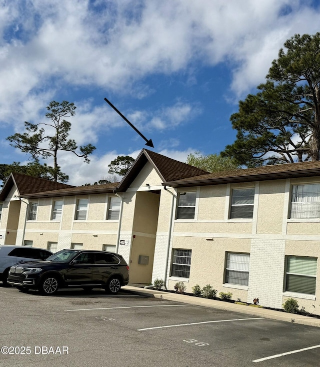 view of property featuring uncovered parking