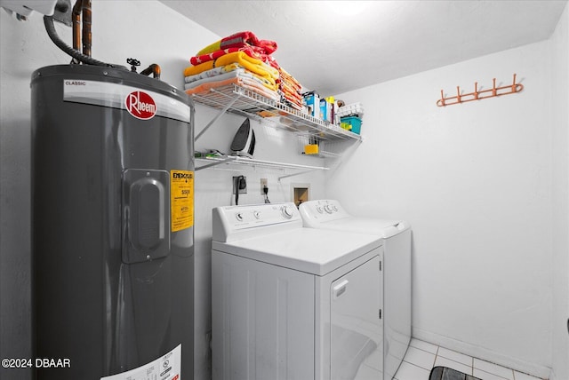 laundry area featuring washing machine and clothes dryer, light tile patterned floors, and water heater