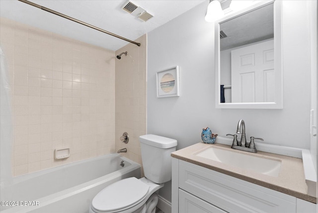 full bathroom with vanity, toilet, and tiled shower / bath