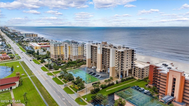 bird's eye view featuring a water view and a beach view