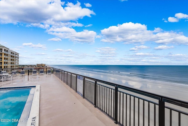 balcony with a view of the beach and a water view