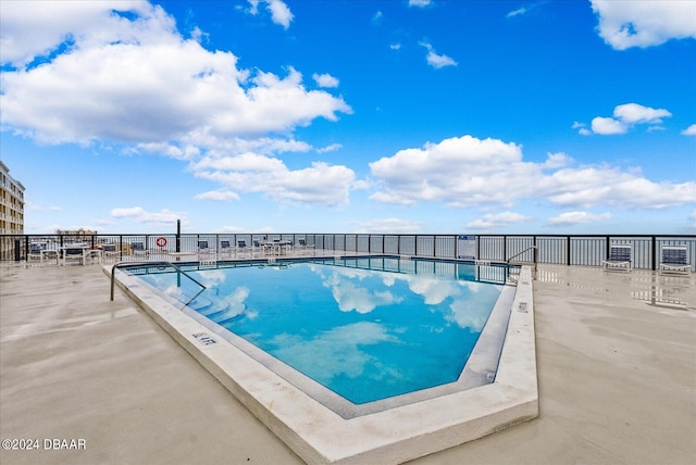 view of swimming pool featuring a patio area