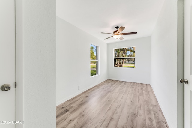 empty room featuring light wood-type flooring and ceiling fan