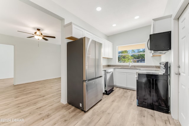 kitchen with stainless steel appliances, sink, light hardwood / wood-style floors, white cabinets, and ceiling fan