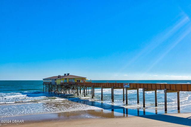 dock area featuring a water view and a view of the beach