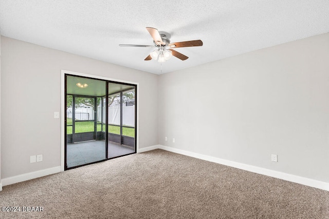 spare room with ceiling fan, a textured ceiling, and carpet flooring