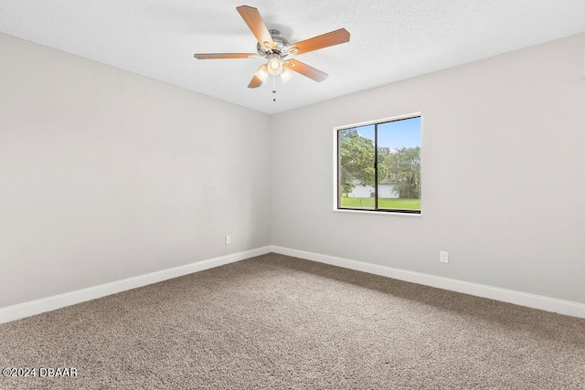 empty room featuring carpet flooring and ceiling fan