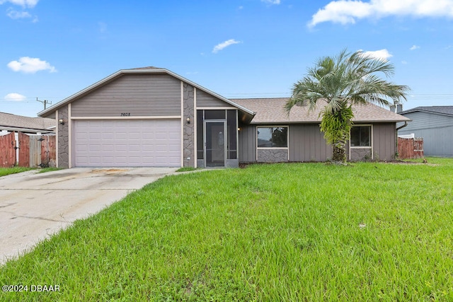 single story home featuring a front lawn and a garage