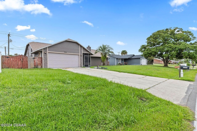 ranch-style home featuring a garage and a front lawn