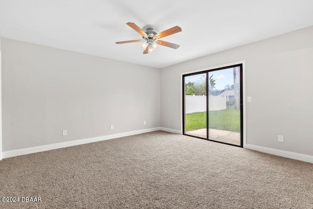 spare room featuring ceiling fan and carpet floors