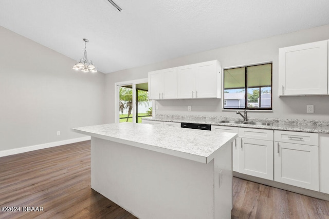 kitchen featuring white cabinets, sink, and decorative light fixtures