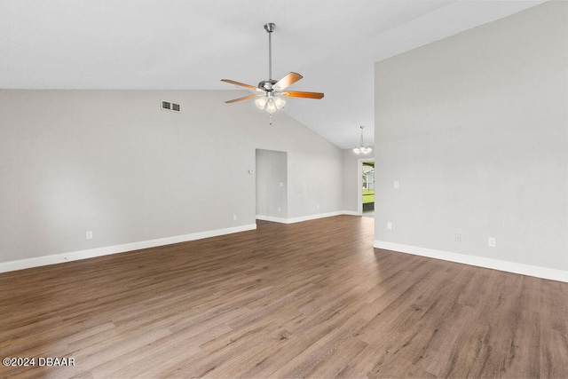 unfurnished living room featuring ceiling fan with notable chandelier, light hardwood / wood-style flooring, and lofted ceiling