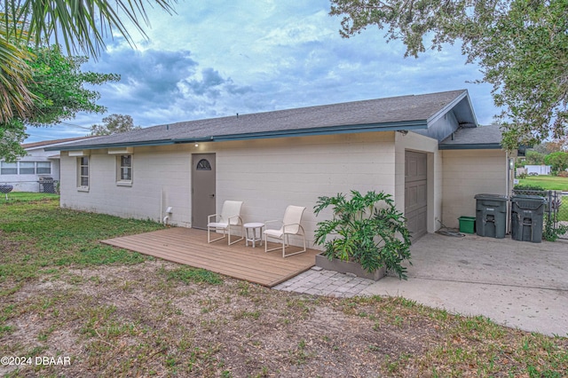 back of house featuring a wooden deck