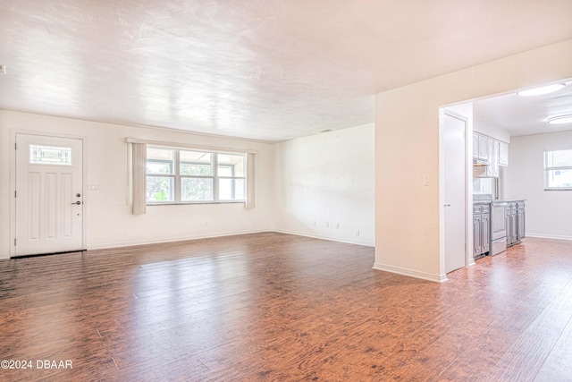 unfurnished living room with wood-type flooring