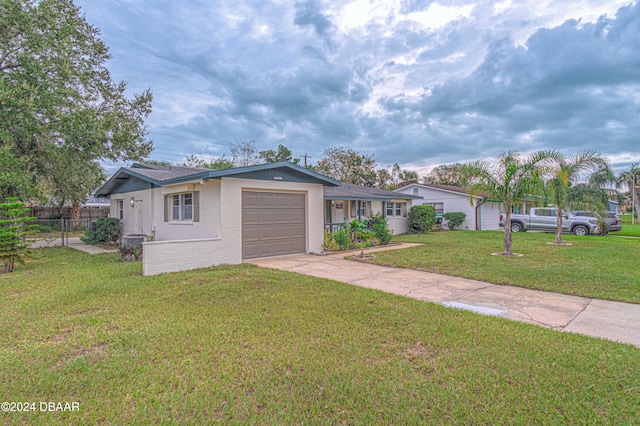 single story home featuring a garage and a front yard