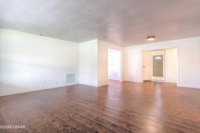 unfurnished room featuring dark hardwood / wood-style floors