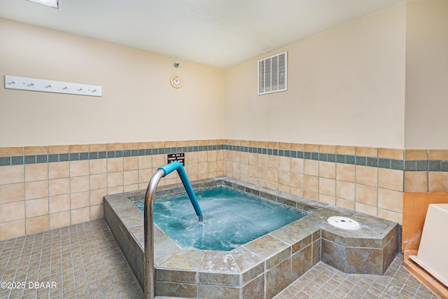 interior space featuring a hot tub, tile patterned floors, and tile walls